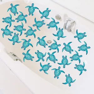 Detailed view of blue sea turtle anti-slip stickers applied inside a clean white bathtub.