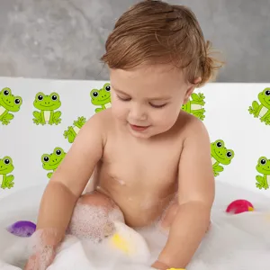 Detailed view of cute green frog anti-slip safety sticker in use inside a baby bathtub.