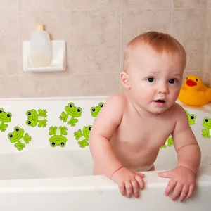 Detailed scene of cute green frog anti slip bathtub stickers in use during baby bath time.