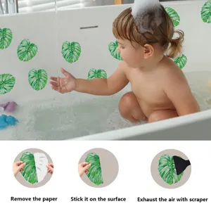 Non-slip bathtub stickers with green monstera leaf design, easy to apply for bathroom safety.