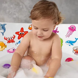 Cute cartoon marine animal non-slip stickers applied inside bathtub for baby safety.