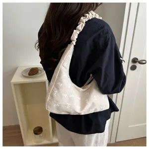 Fashion casual canvas shoulder bag with cute bow embroidery and stylish pleated strap design.