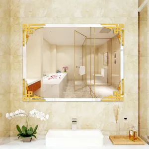 Detailed view of a decorative rectangular bathroom mirror with stylish gold corner stickers.