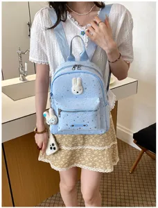 Detail view of the stylish light blue mini backpack featuring cute plush rabbit decor and starry print.