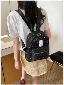 Stylish black star print backpack for women, casual daily daypack with cute rabbit patch.