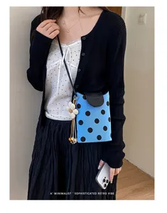 Blaue Umhängetasche mit Punkten und Blumenanhänger für Damen, ideal für den täglichen Weg.