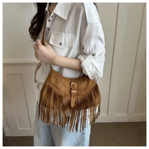 Brown suede fringe crossbody bag detail, featuring metal buckle and stylish retro tassels.