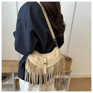 Retro suede fringe shoulder bag detail, stylish crossbody bag with metal buckle and long tassels.