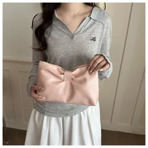 Pink bow clutch bag for women, stylish minimalist underarm bag for commute and daily use.