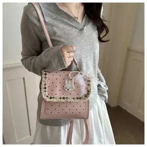 Pink polka dot backpack with bunny charm, cute school bag for girls and women daily use.