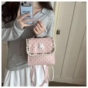 Pink polka dot backpack with cute rabbit patch and sweet fringe detailing for daily style.