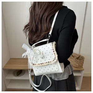 Cute white polka dot backpack for women with sweet lace ribbon and lovely rabbit decor detail.