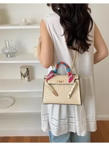 Beige ostrich pattern fashion shoulder handbag detail view showing chic colorful scarf handle.