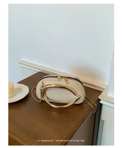 Minimalist retro style chic women shoulder bag with bold gold handle and elegant chain strap.