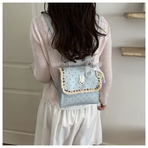 Light blue polka dot backpack with cute lace trim and rabbit applique for daily style.