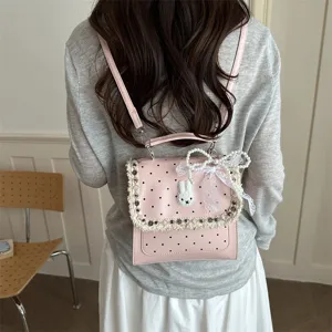 Pink polka dot backpack for women and kids featuring cute rabbit embroidery and bow.