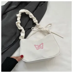Borsa a tracolla in nylon bianco con ricamo di farfalla rosa e manico arricciato.