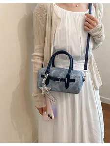 Detailed view of the vintage denim barrel shoulder bag with chic handle and stylish strap.