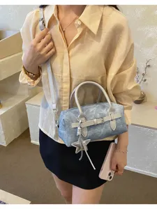 Detailed view of the trendy retro denim pillow crossbody handbag with star pendant and chic buckle.