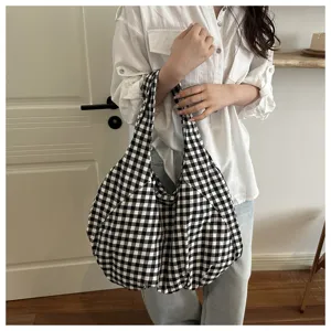 Casual black and white checkered shoulder bag detail showing soft fabric texture and daily wear style.