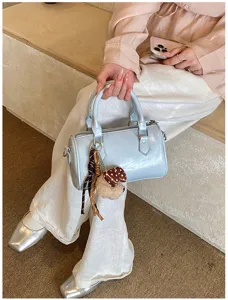 Chic patent leather Boston handbag for women, trendy daily shoulder bag with cute charm.
