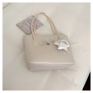 Elegant beige PU leather tote shoulder bag with cute bow and star pendant for women.