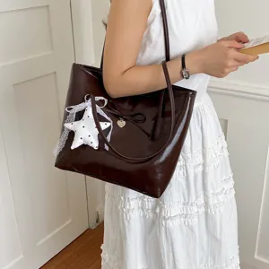 Dark brown vintage oil leather tote bag for women, chic bow and star pendant shoulder handbag.