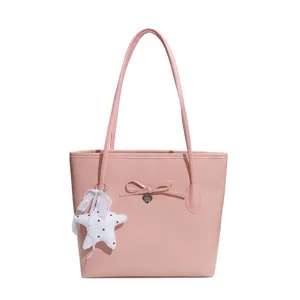 Pink PU leather tote bag for women, stylish shoulder handbag with cute star pendant and bow.