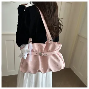 Pink ruffled shoulder bag detail shot, featuring star prints and cute star pendant accessory.