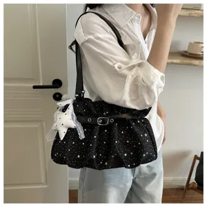 Detail view of black star-pattern shoulder bag with cute lace star pendant and stylish buckle strap.