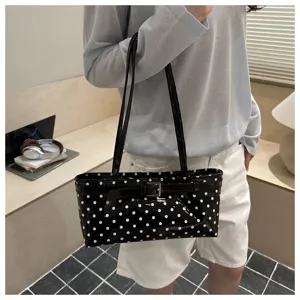 Chic women's polka dot patent leather shoulder bag with chic buckle design for daily wear.