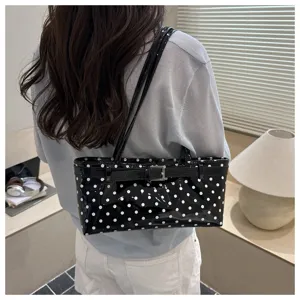 Chic black patent leather polka dot shoulder bag, stylish casual handbag product detail view.
