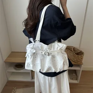 Chic white star print shoulder bag with cute lace star pendant for daily stylish wear.