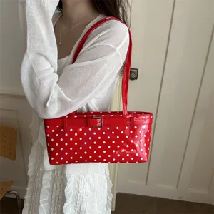 Stylish red polka dot patent leather handbag for women, chic buckle shoulder crossbody bag.