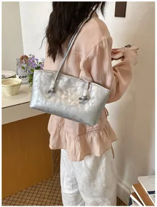 Stylish metallic silver shoulder bag for women, trendy underarm tote purse with chic knot.