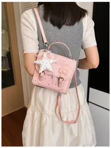 Zaino piccolo rosa con stampa stelle da donna, borsa a tracolla alla moda con ciondolo.