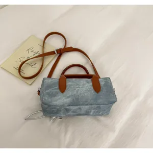 Vintage denim barrel shoulder bag for women, casual stylish cross body pillow bag with leather handles.