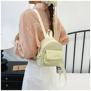 Casual plaid mini backpack detail view, featuring soft fabric and front pocket design.
