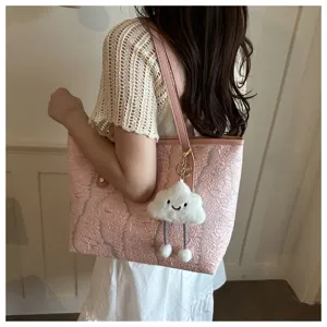 Pink textured tote bag with cute cloud keychain, showing daily fashion and spacious capacity.