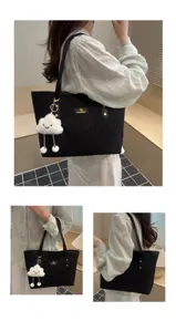 Detailed view of the black textured tote bag with cute cloud pendant, shown in daily wear.