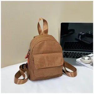 Cute brown plaid mini backpack for casual daily use, featuring front pocket and top handle.