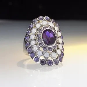 Exquisite oversized statement ring featuring a central purple crystal surrounded by white and violet stones.