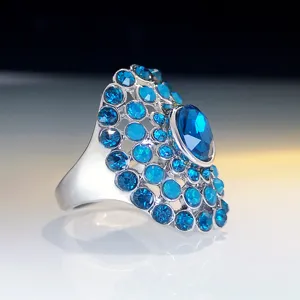 Stunning blue crystal cluster ring detail, sparkling rhinestone statement cocktail jewelry design.