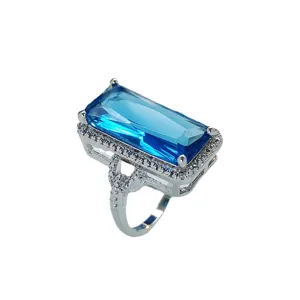 Fashion rectangular blue gemstone ring with pave rhinestones and ornate split shank band.
