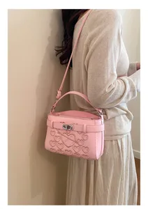 Pink embossed heart shoulder bag detail showing stylish crossbody design for women daily wear.