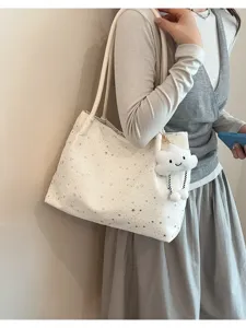 Stylish star print canvas shoulder tote bag with cute cloud plush pendant accessory.