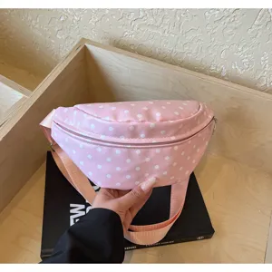 Casual pink polka dot fanny pack for women, stylish waist sling bag with adjustable strap.