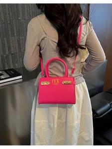 Pink leather crossbody bag with top handle and gold hardware, chic daily shoulder purse for women.