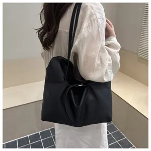 Minimalist black leather slouchy tote bag, large capacity shoulder bag with stylish belt detail.