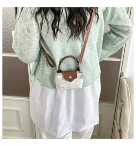 Mini crossbody bag for women, cute star print handbag with brown leather flap and strap.